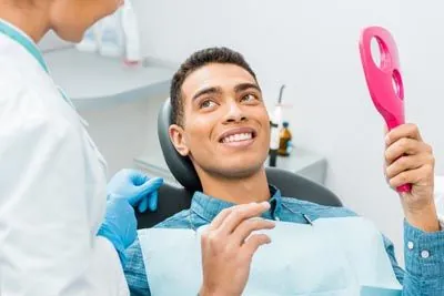 man loving the results of his cosmetic dental procedure