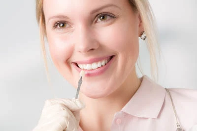 woman choosing dental veneer color at Beacon Hill Dental
