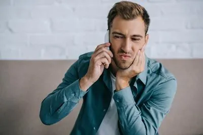 man experiencing tooth pain